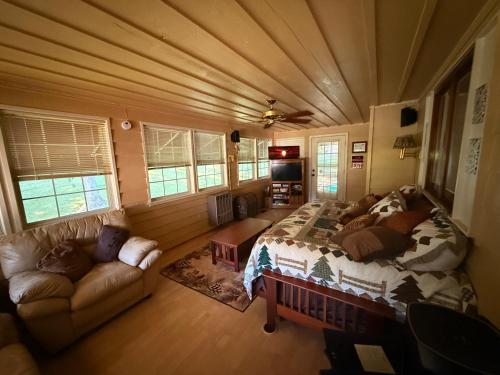 a bedroom with a bed and a couch in a room at The Downer House in Chattanooga