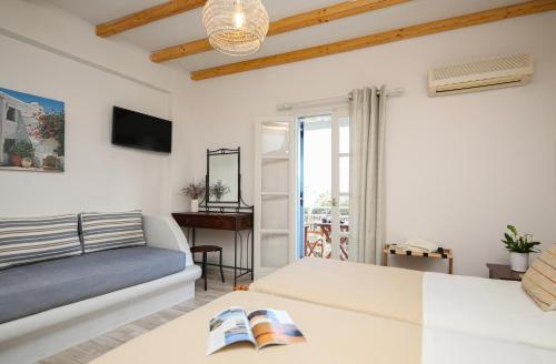 a living room with a couch and a table at Ioanna Apartments in Agios Prokopios
