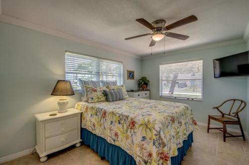 a bedroom with a bed and a ceiling fan at TIPSY TIKI - Pool, Canal, Outdoor Bar, King Bed in Cape Coral