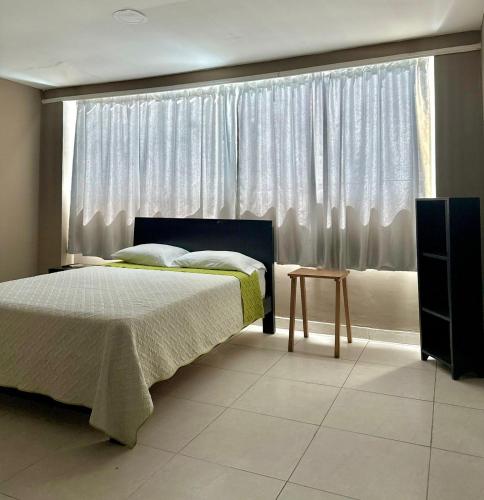 a bedroom with a bed and a large window at hotel gloria del norte sas in Cartagena de Indias