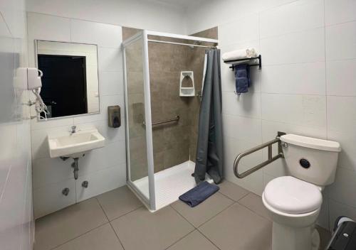 a bathroom with a shower and a toilet and a sink at The Hostel Santiago in Santiago
