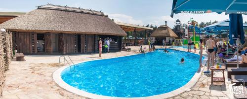 a large swimming pool in a resort with people in it at Ресторан Отель Гуляй Поле in Novomoskovsʼk