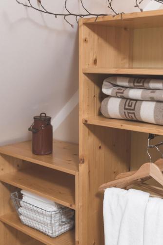 a wooden closet with towels and towels at Brunarica in Bohinj