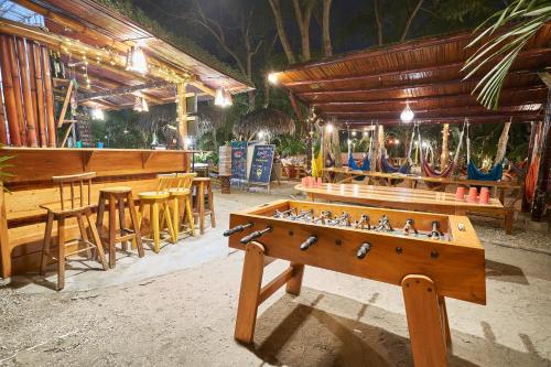 a tables and chairs and a table and a table sidx sidx sidx at Hidden Hostel in Montañita