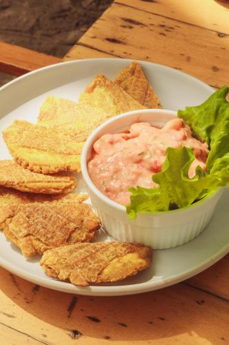 a plate with a bowl of dip and tortilla chips at Casa Chapolin Boutique Guesthouse in Palomino