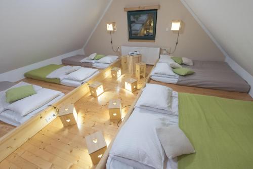 a room with three beds in a attic at Brunarica in Bohinj