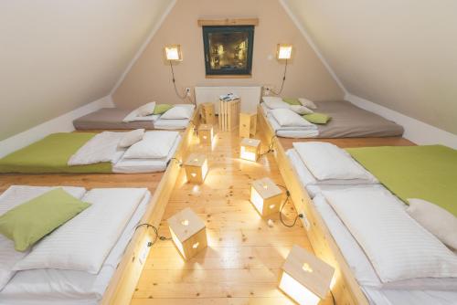 a room with four beds in a attic at Brunarica in Bohinj