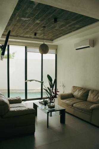 a living room with a couch and a table at Casa Calec 2BR Apartment with Pool & Terrace in Manzanillo