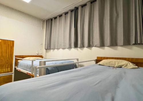 a hospital room with two beds and a window at The Hostel Santiago in Santiago