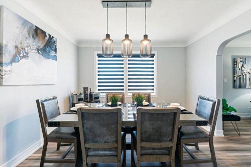 a dining room with a table and chairs and a window at Outdoor Sauna Hot Tub Playroom Port Dallhousie in St. Catharines