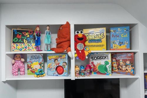 a shelf with toys and other toys on it at Outdoor Sauna Hot Tub Playroom Port Dallhousie in St. Catharines