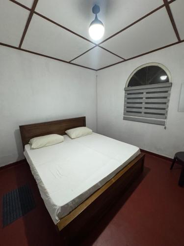 a bedroom with a bed in a room with a window at Seliya Villa Retreat in Balapitiya