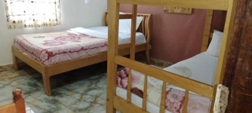 two bunk beds in a small room with at Gorilla African Guest House in Entebbe