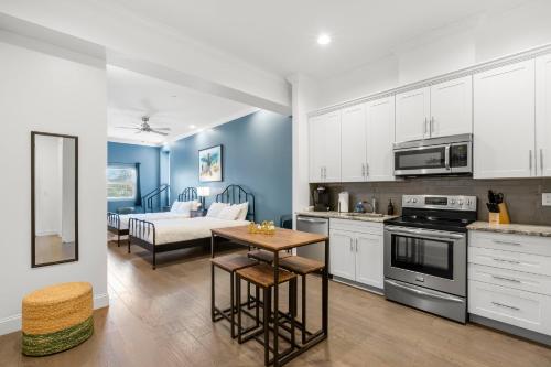 a kitchen and living room with a table and a couch at Casa Ybor Apartments on 7th Ave in Tampa
