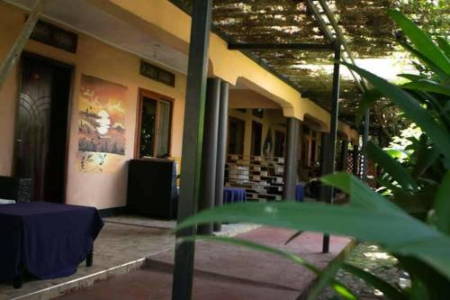 a building with a table in front of it at Gorilla African Guest House in Entebbe