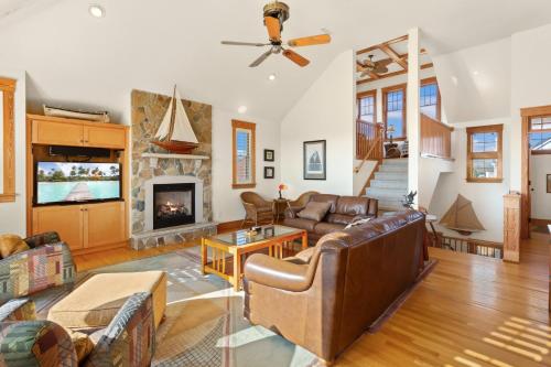 a living room with leather furniture and a fireplace at 1812 - The Original Sound and the Fury in Poplar Branch