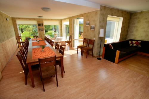 a living room with a table and chairs and a couch at Kaare Guesthouse in Viljandi