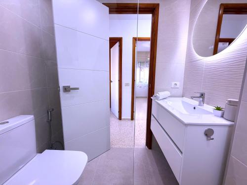 a bathroom with a toilet and a sink and a mirror at Tropicalidays Palmeras del Sur in Adeje