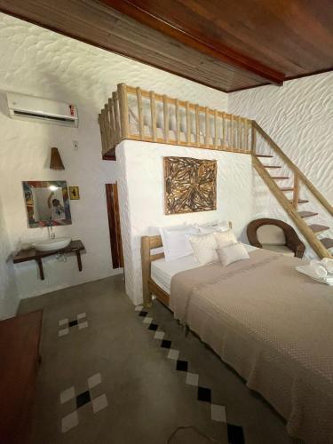 a bedroom with a bed and a staircase in it at Bougainville Icaraí de Amontada in Amontada