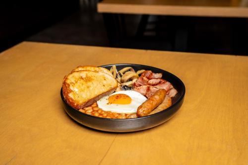 a plate of breakfast food with a fried egg and toast at Luxapart III Beautiful Views with Breakfast in Košice