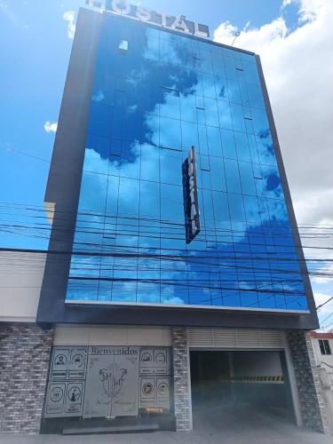 a building with a sign on the side of it at Hostal Manhatan Condado in Quito