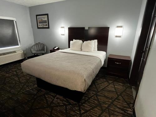 a hotel room with a bed and a television at Quality Inn Grand Rapids Near Downtown in Grand Rapids