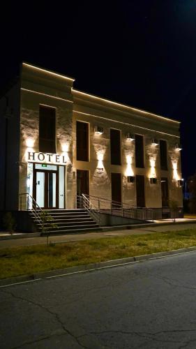 a building with a hotel with lights on it at Sherline Hotel in Urganch