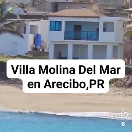 a house on the beach with the words villa mula del mar en acc at Villa Molina Del Mar in Arecibo