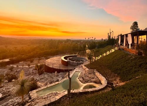 a building with a pool on top of a hill at Pegaso Retreats San Miguel de Allende in San Miguel de Allende
