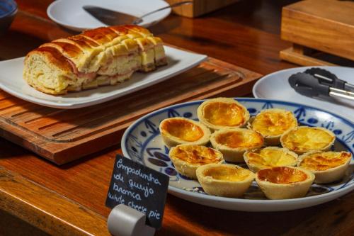 a plate of food with a sandwich and orange slices at Pousada Casa dos Autores in Paraty
