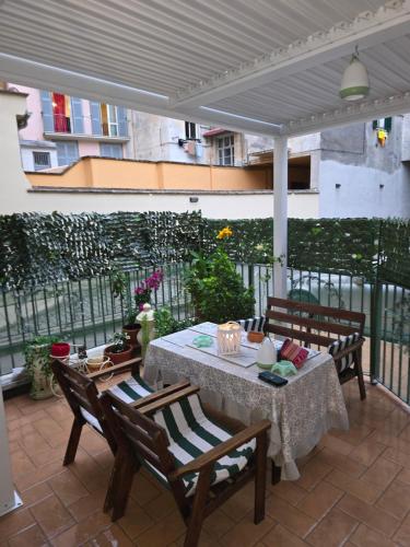 a patio with a table and chairs and a fence at La Speranza in Viterbo