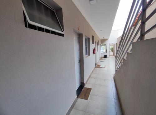 an empty hallway of a building with stairs and a room at Studio - Ótima localização Mobiliado in Barretos