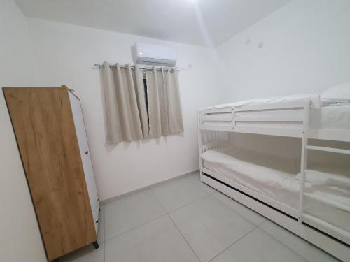 a room with an empty refrigerator and a curtain at שירת רבקה in Tiberias