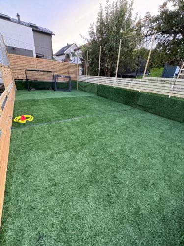 a artificial lawn with a frisbee on it at Lisas apartment, private new 1 bedroom and 1 living room with sofa bed and big windows, share with nobody in Oslo
