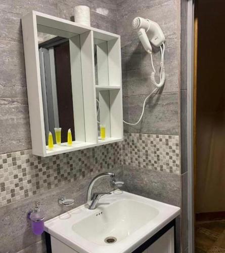 a bathroom with a sink and a mirror at Bedouin Camp&tour in Wadi Rum
