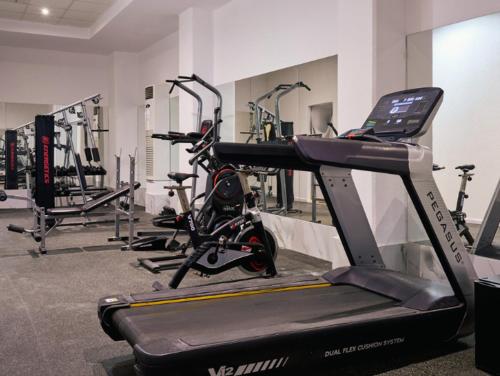 a gym with several exercise bikes and a treadmill at Blue Sea Island in Kolimbia