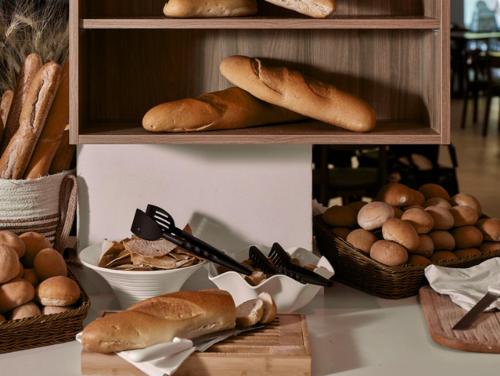a shelf with bread and eggs on a table at Blue Sea Island in Kolimbia