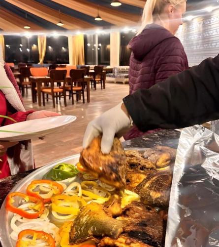 a person in gloves preparing food on a table at Bedouin Camp&tour in Wadi Rum