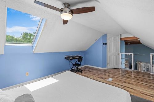 a bedroom with blue walls and a ceiling fan at Pirate's Cove Bungalow in Conway