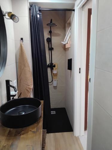 a bathroom with a black sink and a shower at Hawaii house in Puerto del Rosario