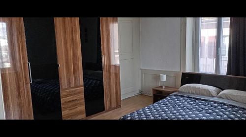 a bedroom with a bed and an open door at Chambre 4 au centre in Biel