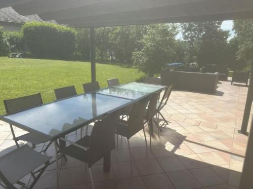 a table with chairs and an umbrella on a patio at Havre de paix in Chainaz-les-Frasses