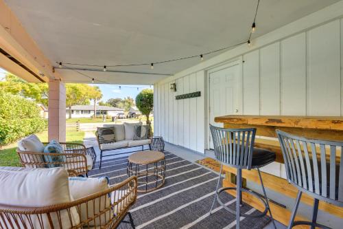 a porch with chairs and a couch and a table at 5 Blocks to Jax Beach Getaway with Patio and Yard! in Jacksonville Beach