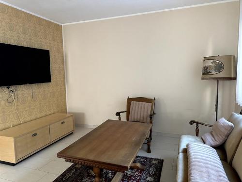 a living room with a table and a couch at Residenz Elegance in Bochum