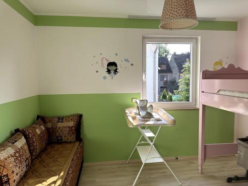 a room with a couch and a table and a window at Residenz Elegance in Bochum