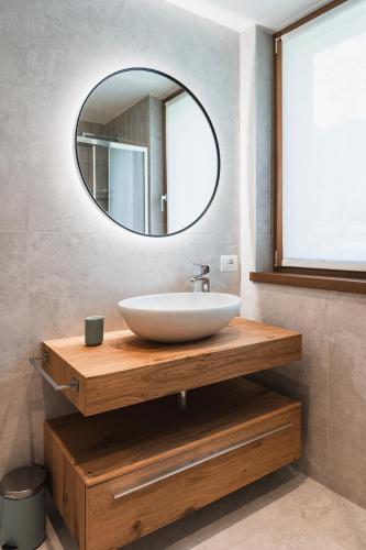 a bathroom with a white sink and a mirror at Casa Stefania 1 in Pieve Di Ledro