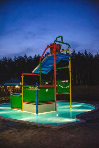 a roller coaster in a park at night at Ресторан Отель Гуляй Поле in Novomoskovsʼk