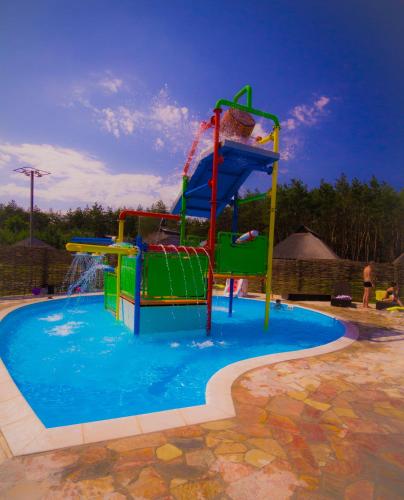 a water park with a water slide in a pool at Ресторан Отель Гуляй Поле in Novomoskovsʼk