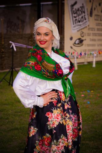 a woman dressed in a dress with flowers at Ресторан Отель Гуляй Поле in Novomoskovsʼk