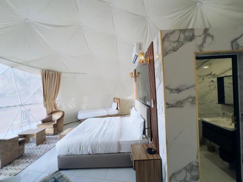 a bedroom with a bed and a sink and a mirror at Rum STAR luxury camp in Wadi Rum